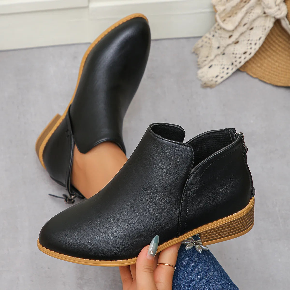Black leather ankle boots with a pointed toe, side zip and low stacked block heel
