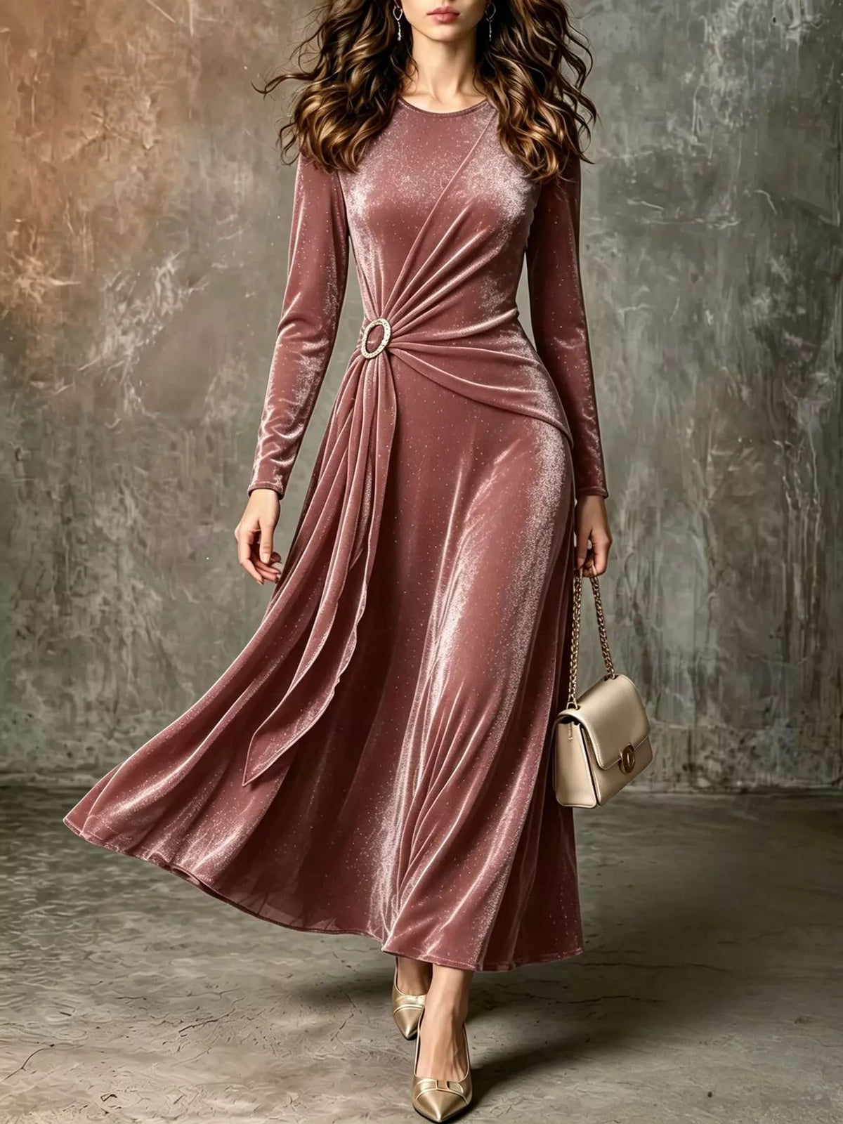 Woman in a dusty pink velvet long-sleeve maxi dress with a ring detail and twist at the waist