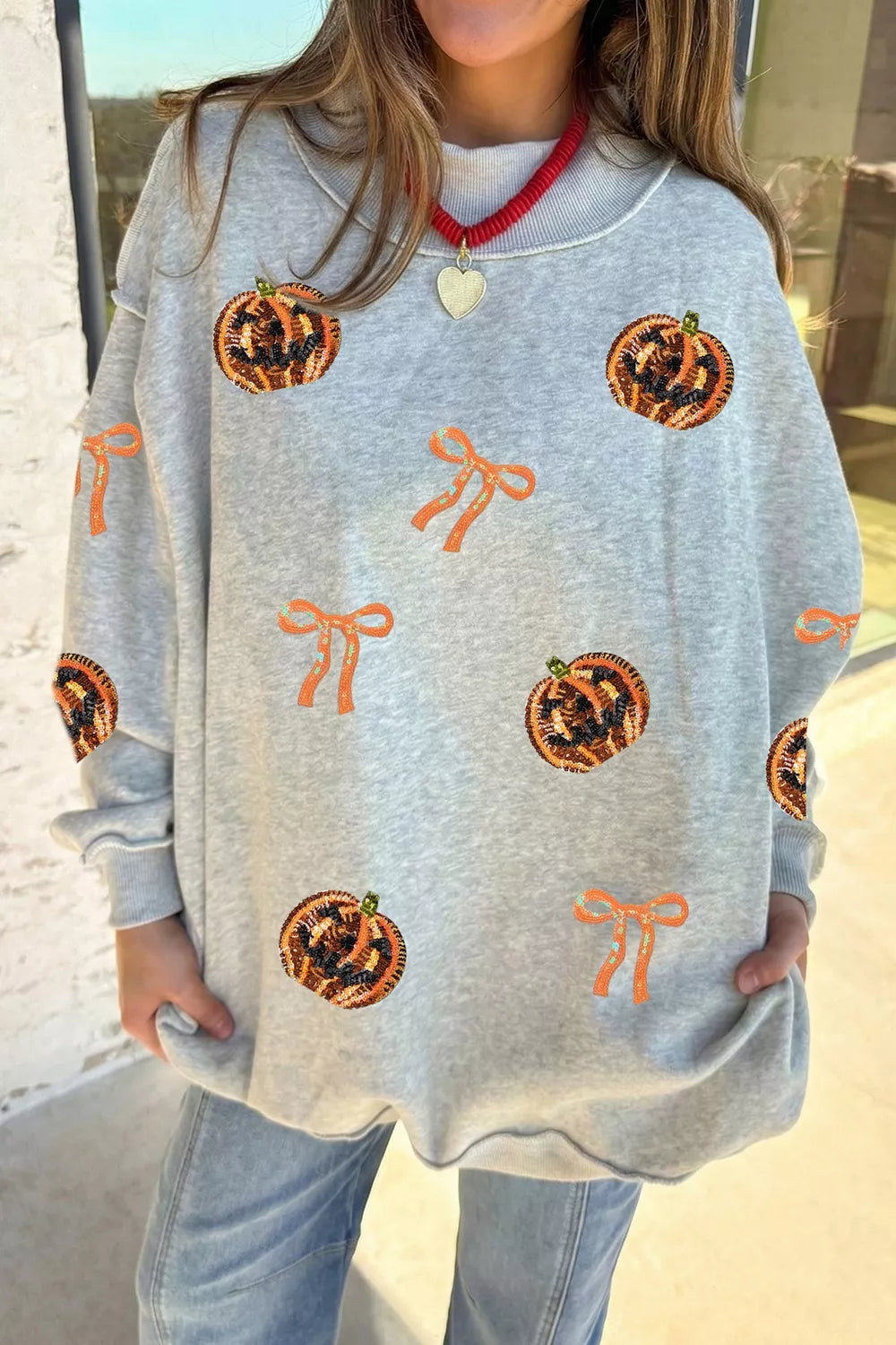 Sequin Pumpkin Face Bow Exposed Seam Halloween Sweatshirt - Lilixa.store