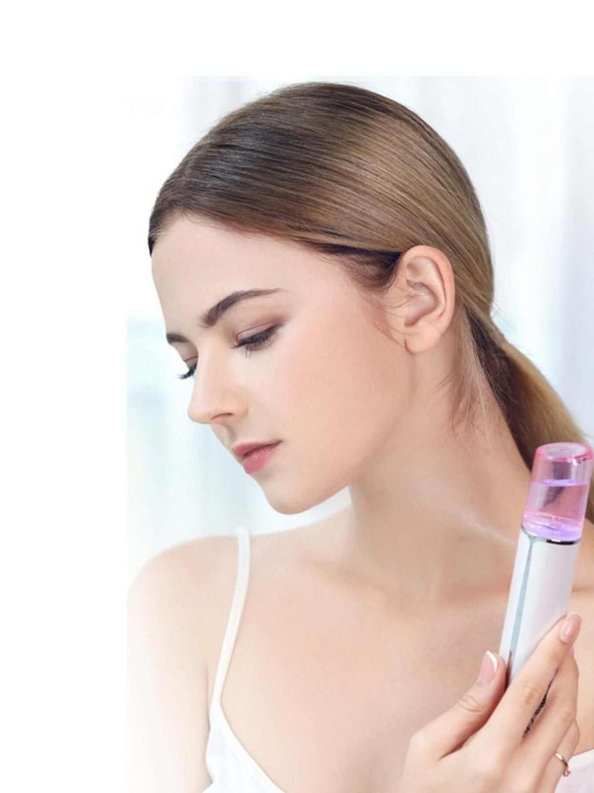 Woman holding Portable Facial Mister Nano Sprayer with a focus on skin hydration and beauty care.