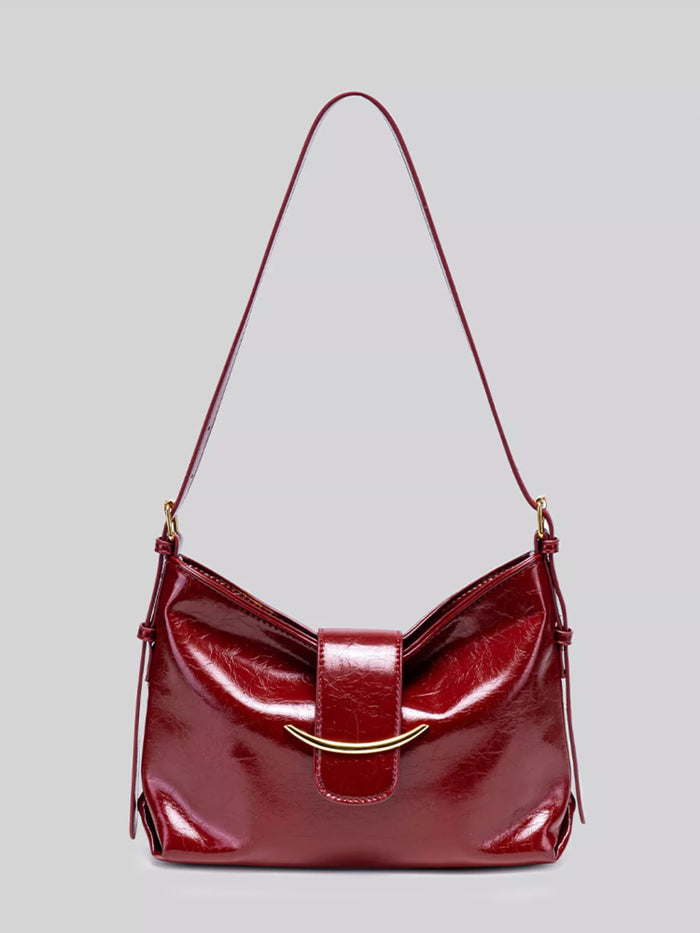 Elegant Glossy Patent Leather Shoulder Bag with Crescent Gold Accent in Wine Red